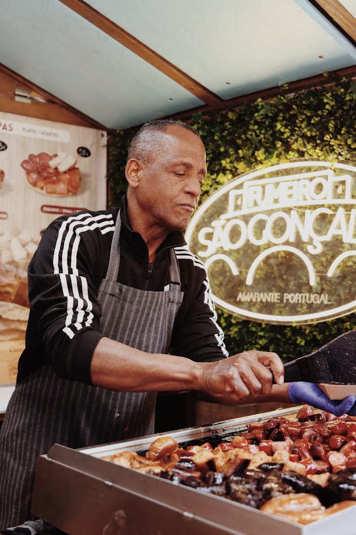 why-choose-us Street food vendor grilling Portuguese cuisine in Lisbon, Portugal.